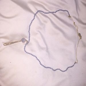Necklace with blue beads and a charm